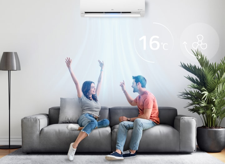 A man and a woman enjoying the cool breeze under an air conditioner set to 16 degrees	