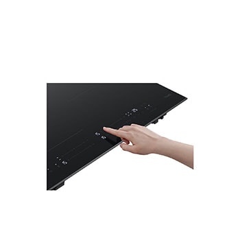 hand with switch oning Induction Cooktop 