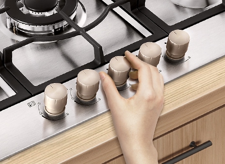 Image of turning gas Knob by hand.