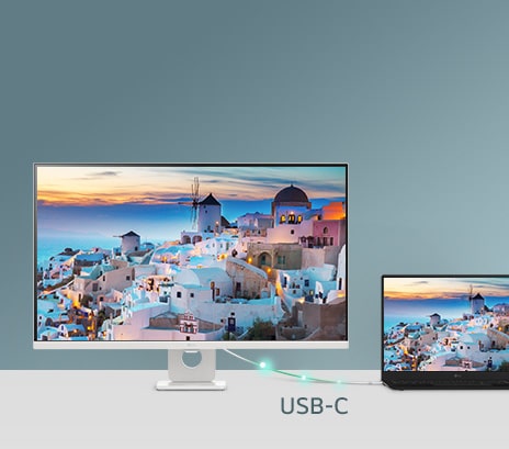 A photo showcasing a smart monitor connected to a laptop via USB-C, demonstrating charging and data transfer.	