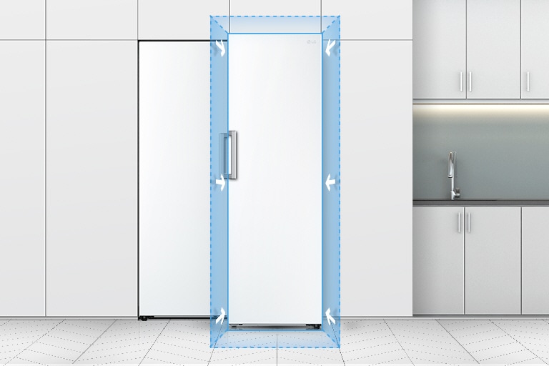 The front view of the refrigerator is shown in a kitchen. A blue square on the edge of the refrigerator and arrows highlight how it fits seamlessly into a standard kitchen.