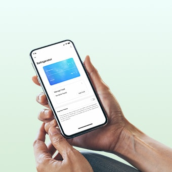 Hands holding a phone with LG ThinQ app on