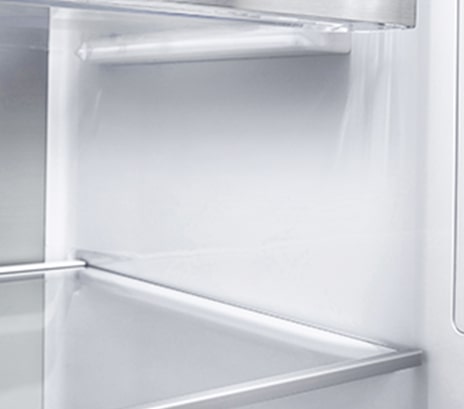A diagonal view of the shelf with metallic paneling on the interior of the refrigerator.
