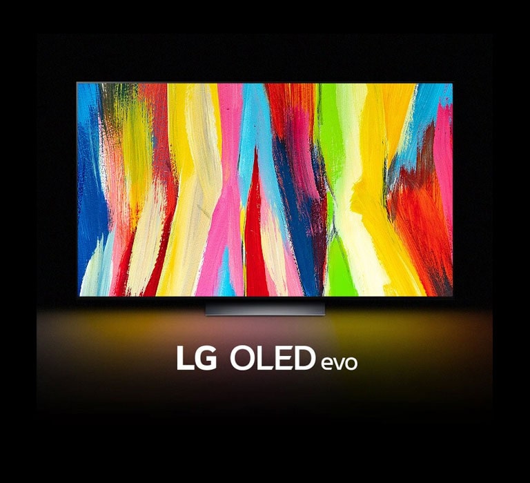 An LG OLED C2 is in a dark room with a colorful abstract artwork of vertical lines on its display and the words "LG OLED evo" underneath.