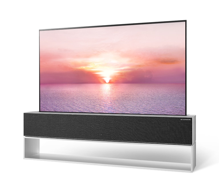 Quarter view of LG SIGNATURE Rollable OLED TV with sunrise background image on the screen.