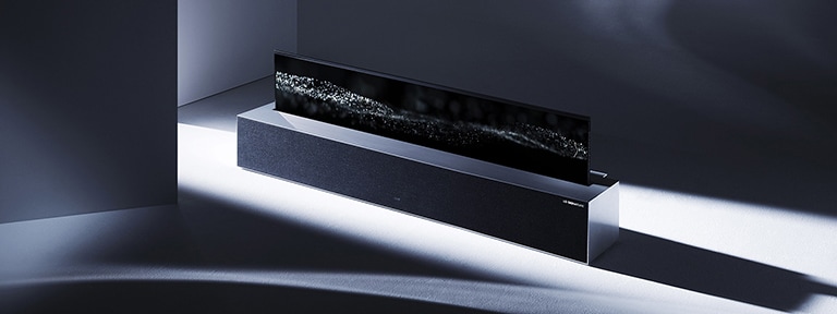 An image of LG SIGNATURE Rollable TV in line view placed in the middle of a grey-colored space.