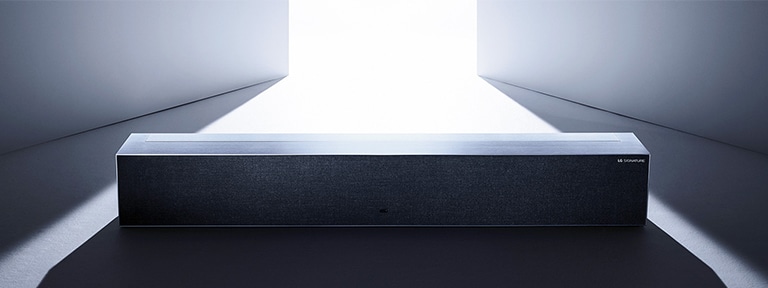 An image of LG SIGNATURE Rollable OLED TV in zero view located in a grey-colored space.