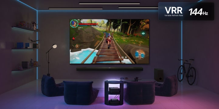A dimly lit living room with a game screen depicted on the QNED9M. Zero Connect Box sits inside a coffee table. VRR logo and 144Hz logo are also visible.
