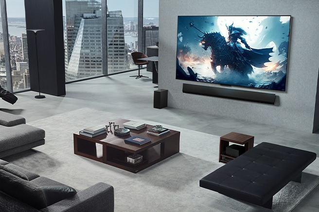 Living room with a person playing a video game on his wall-mounted LG True Wireless TV and LG Soundbar. He holds a controller in his hand, but the gaming console is not immediately visible. There are also no visible wires. The Zero Connect Box is tucked away, barely seen under a side table.