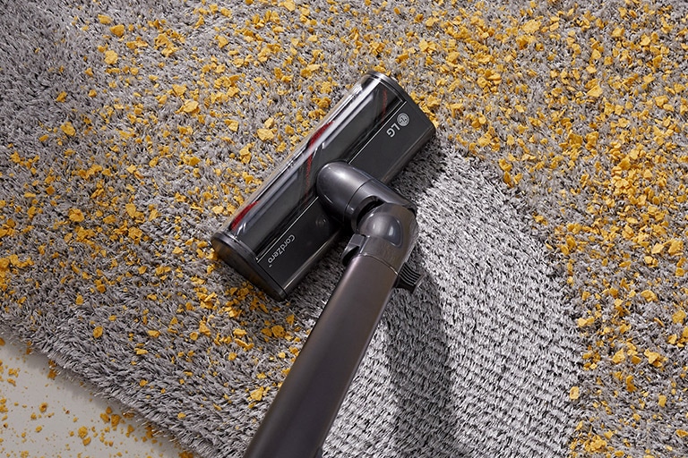 Three images in line: the first shows the vacuum vacuuming dirt from a hard surface, second shows vacuuming chips from a carpet, and the third shows the Power Punch on bedding.