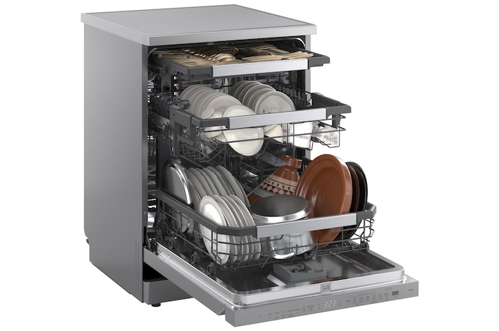 Angled view of LG dishwasher with three open racks fully loaded with dishes