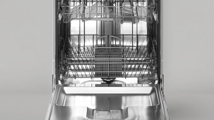 The dishwasher door is open, revealing the fully stainless steel interior.