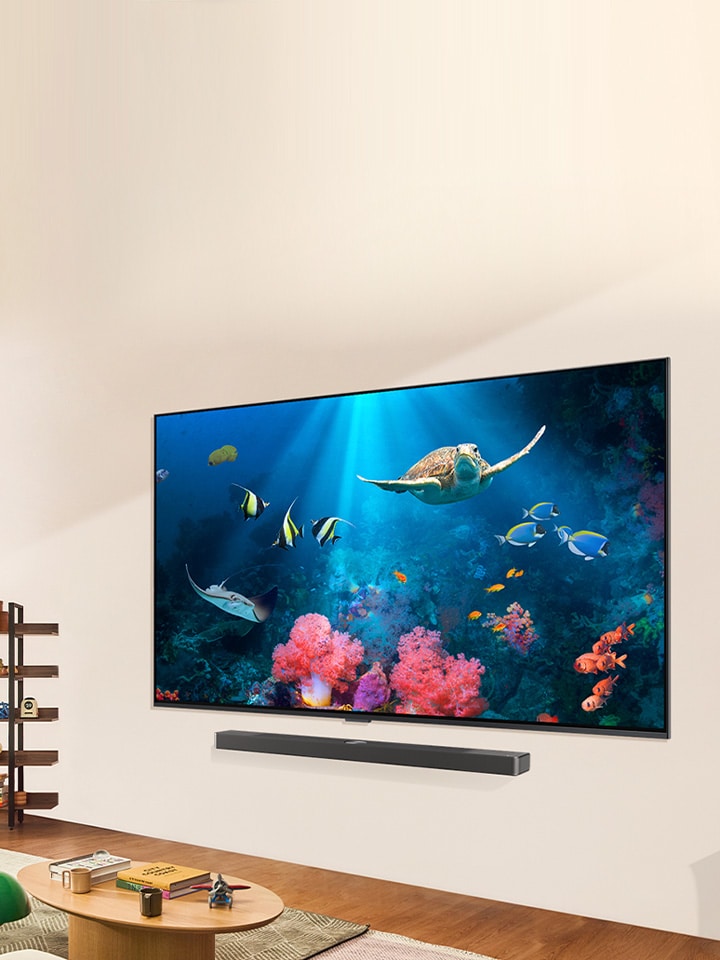 A family is watching a bright aquatic scene on a LG QNED TV with a LG Soundbar, in a bright and natural living space.	