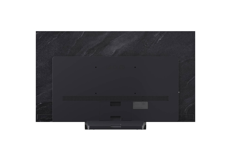 LG OLED evo AI C6 är väggmonterad i ett elegant vardagsrum, med en superslimmad design med smala ramar och visar ett stadslandskap vid en flod vid solnedgången på skärmen. 