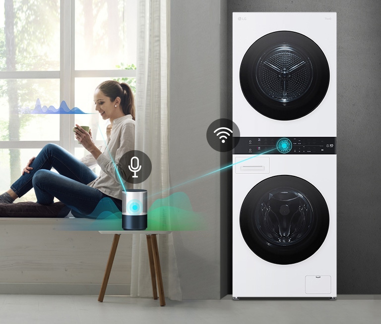 A woman sits in a window holding a drink. She speaks to the AI speaker show by a line from her to the speaker and a sound wave next to her face. The AI speaker then connects to the washer shown with a line and sound waves.