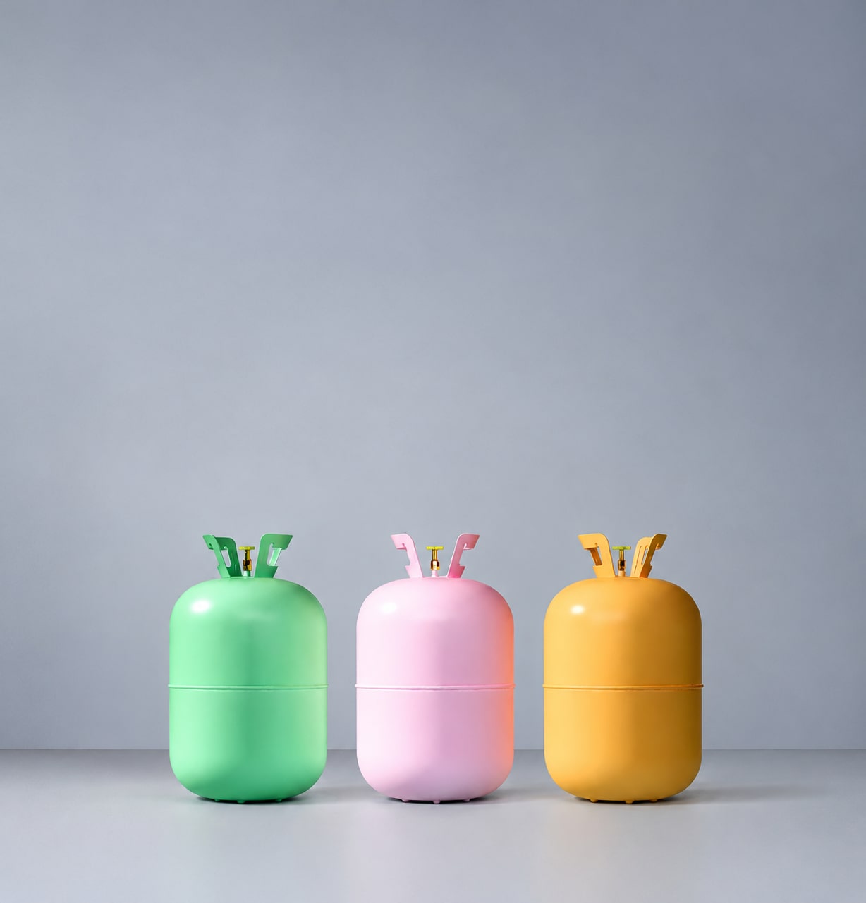 An image showing three refrigerant containers with diverse shades of colour.