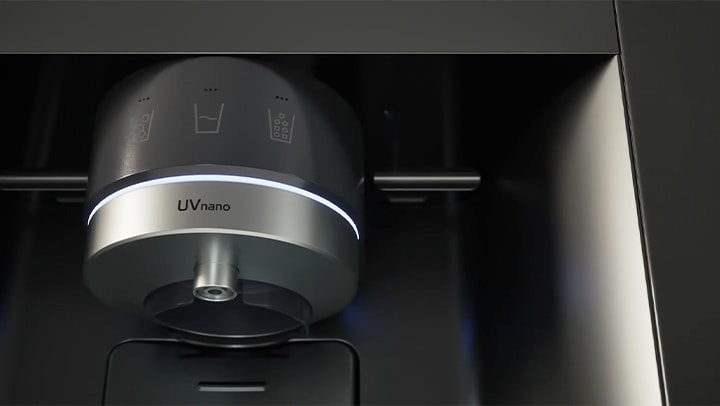 Water being dispensed from a dispenser nozzle with the UVnano feature into a cup filled with ice.	