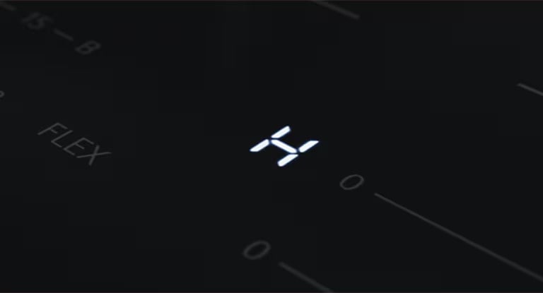The "H" LED light which is a residual heat indicator on the induction hob.