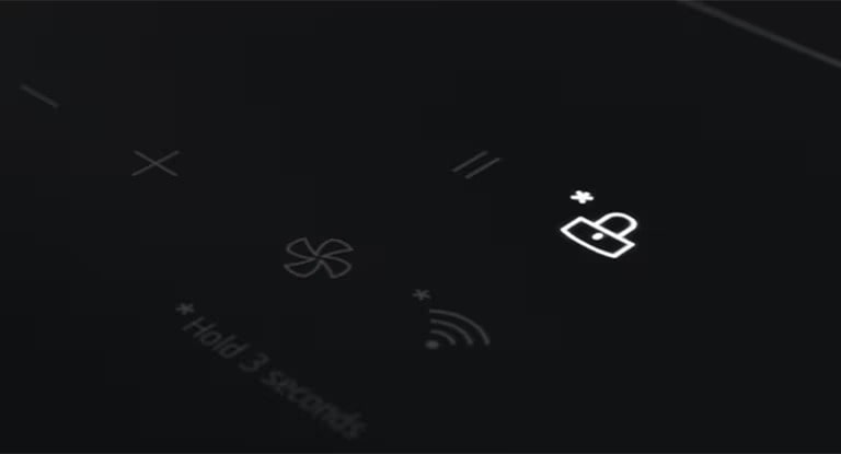 The lock-shaped indicator on the induction hob panel is lit.