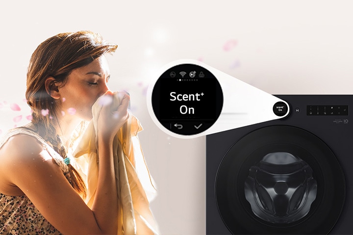 A woman is sitting in front of a washing machine, sniffing the scent of washed clothes.