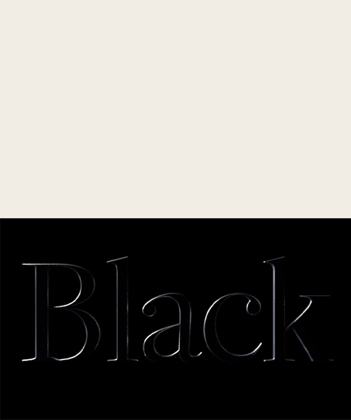 Word black embossed on a black background. 	