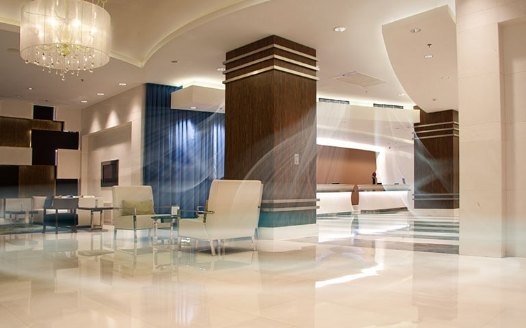 An image of a spacious hotel lobby with air conditioning on.