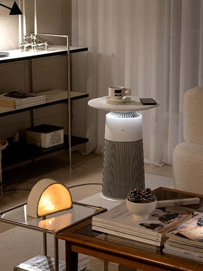 In the middle of the dark living room, the product is placed gently emitting mood lighting. Coffee cups and props are placed on top of the product to serve as tables.