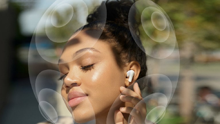 Image of women touching LG TONE Free on her ear. Showing Virtualizer