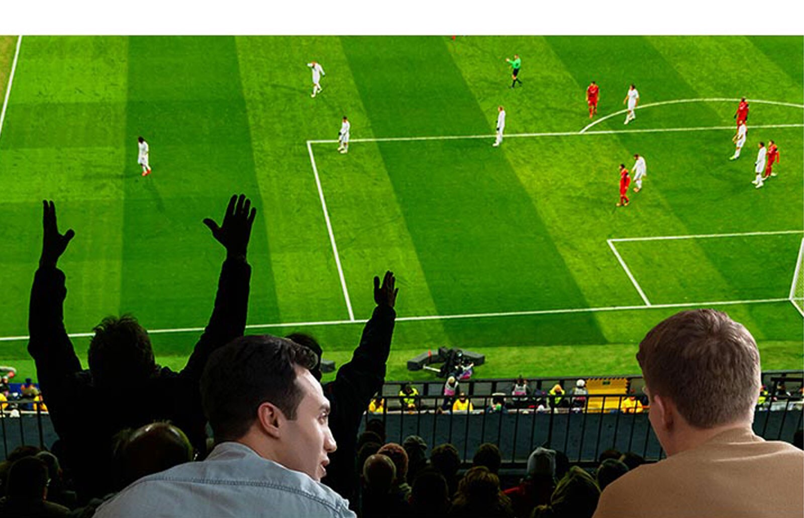 People watching sports game on TV in the living room with ultra large scree TV