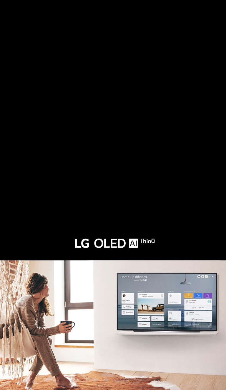 Woman sitting on a chair in the living room with the Home Dashboard on the TV screen