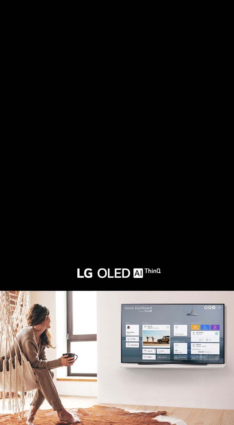 Woman sitting on a chair in the living room with the Home Dashboard on the TV screen