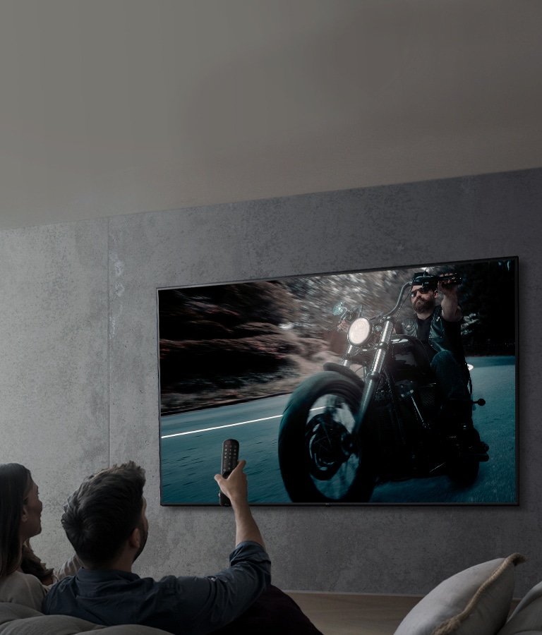 Image affichant un couple regardant une émission sur un téléviseur LG UHD.