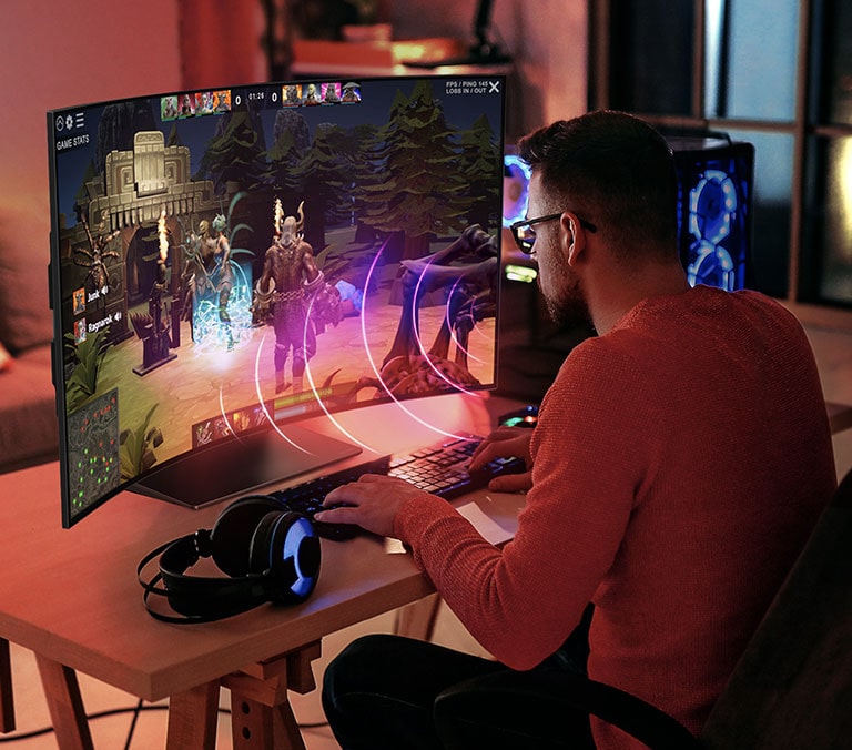 An image of a man playing a game on LG OLED Flex. Sound bubbles depicting speech are shown around his mouth.