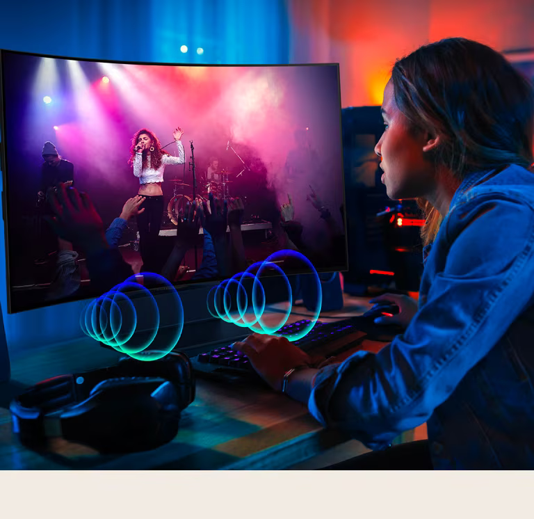 An image of a person watching a concert on LG OLED Flex. Sound bubbles depicting audio emit from the front of the television.