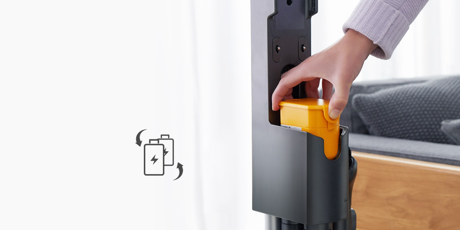 A hand inserts a yellow battery into a sleek, grey device, beside an icon of batteries on a white background.