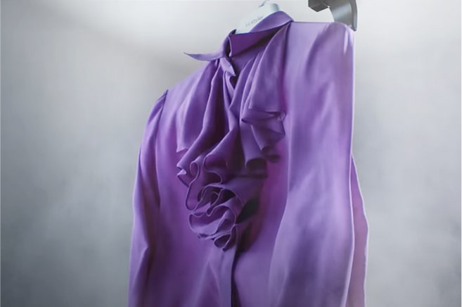 This is an image showing a purple blouse and steam