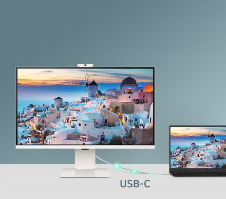 A photo showcasing a smart monitor connected to a laptop via USB-C, demonstrating charging and data transfer.
