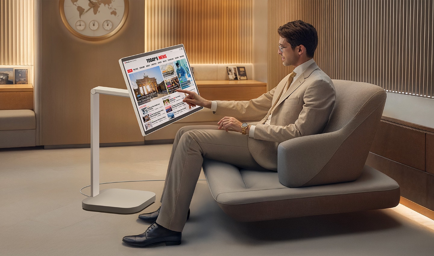 A man in the VIP lounge is reading the news on a LG Smart Monitor Swing.