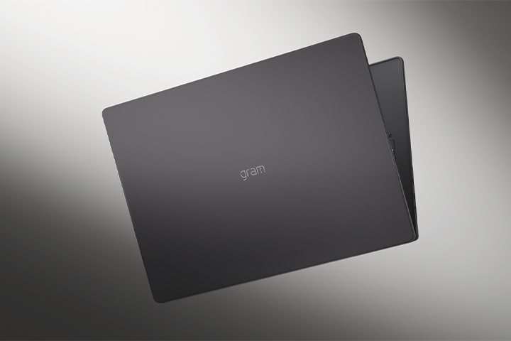 The image shows the cover of a lightweight laptop against a smooth monotone backdrop.