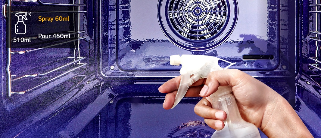 An image of spraying water on the oven wall with a sprayer.