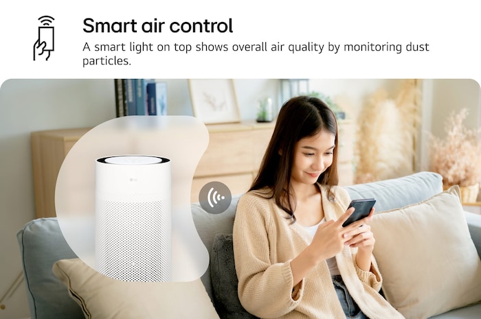 A woman sits on a couch, controlling the LG PuriCare air purifier using the LG ThinQ app on her smartphone. Text reads 'Smart air control: A smart light on top shows overall air quality by monitoring dust particles.'