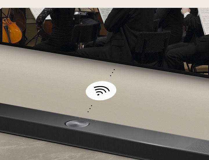 A close up of an LG Soundbar below a LG TV. A connectivity symbol is in between LG Soundbar and a LG TV, showing WOWCAST's wireless operation.