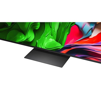 A girl and a dog are seated in front of a LG QNED TV mounted on a wall depicting three elephants walking outwards above a LG Soundbar. The title talks about how every action is more thrilling on a massive screen.
