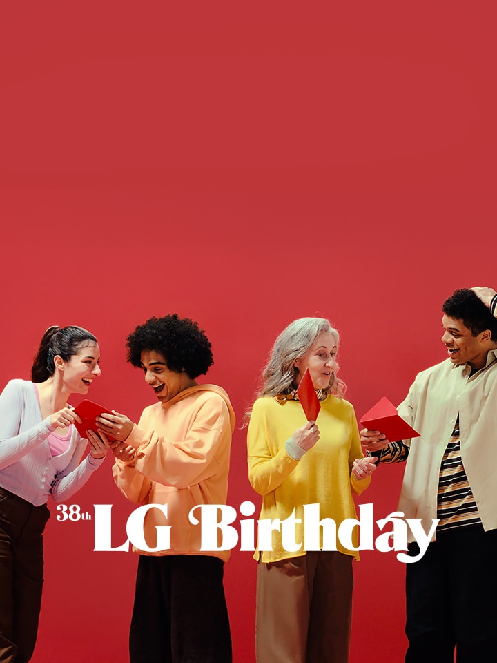 Several people are looking at a small door in a red wall, curious about what the LG Birthday event is.