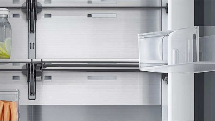 image shows how folding shelf is operated. By simply sliding it back, more space is created to store tall bottles.
