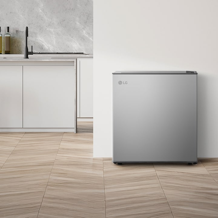 Modern kitchen interior with a 1Door refrigerator placed beside a wooden panel wall and minimalist cabinetry