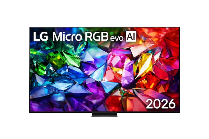 The front view of LG Micro RGB evo AI MRGB95, released in 2026, features a slim black bezel on low-profile feet, with a vivid, crystalline image of sharply defined red, green, and blue facets filling the screen.