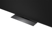 LG Mini RGB evo AI MRGB85 is wall-mounted in a spacious, contemporary living space, displaying a vivid abstract artwork with swirling, multicolored elements.