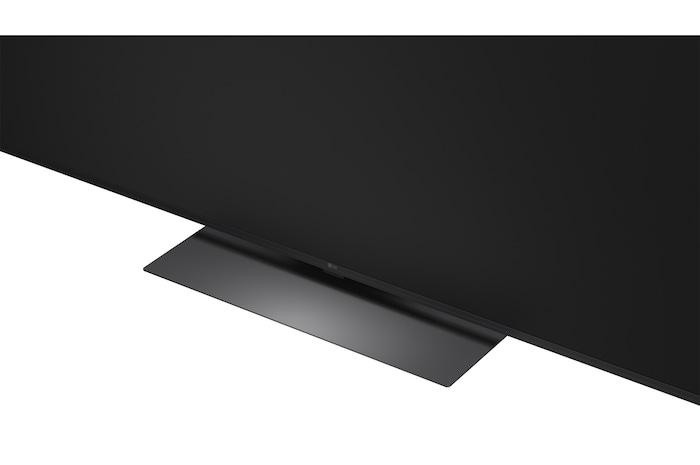LG Mini RGB evo AI MRGB85 is wall-mounted in a spacious, contemporary living space, displaying a vivid abstract artwork with swirling, multicolored elements.