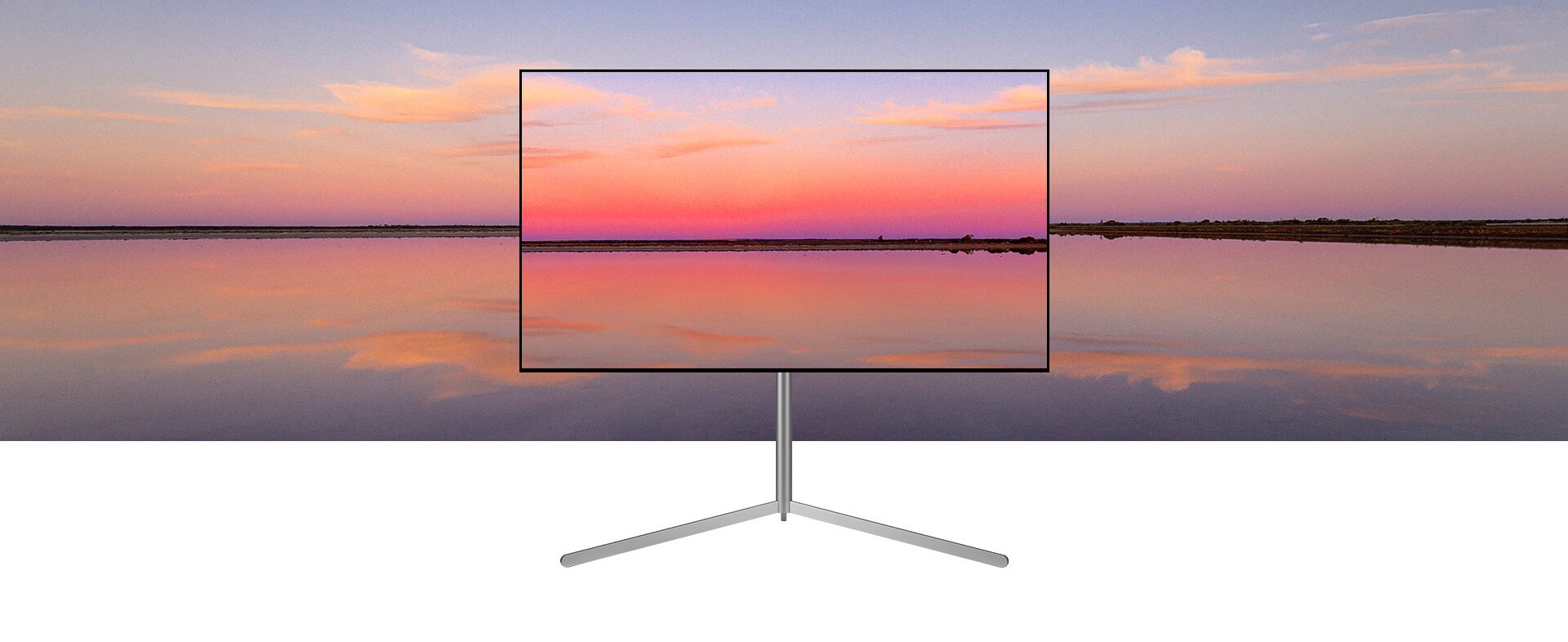 ทีวี LG OLED บน Gallery Stand แสดงภาพพระอาทิตย์ตกสีน้ำเงินและสีชมพูซึ่งผสานเข้ากับพื้นหลัง